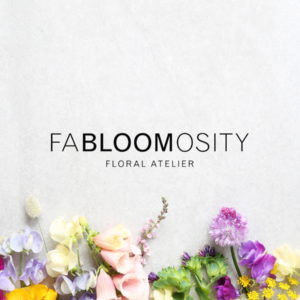 FaBLOOMosity logo on background with flowers