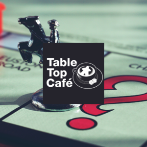 Table Top Cafe logo on top of Monopoly game board